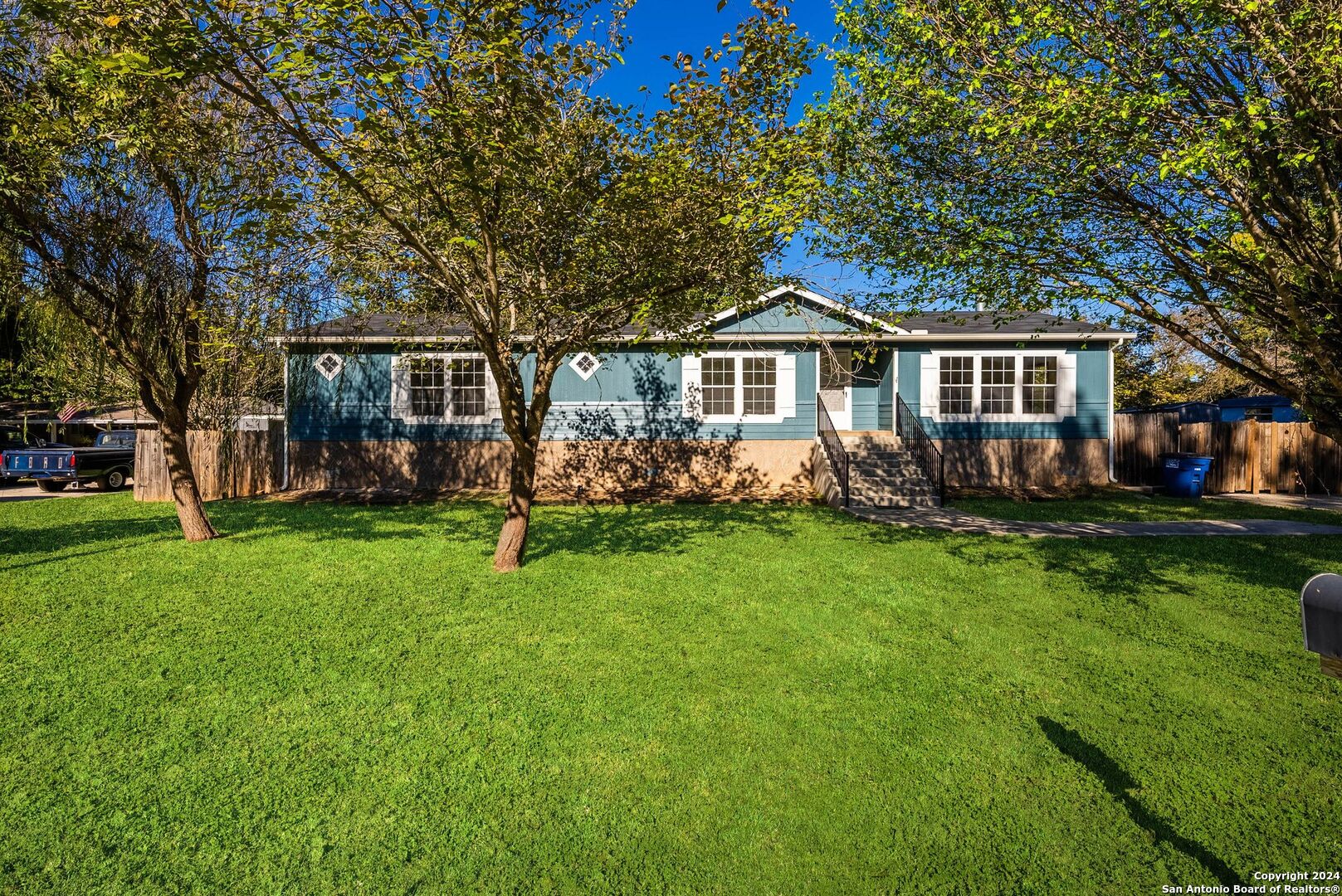 a front view of house with yard and green space