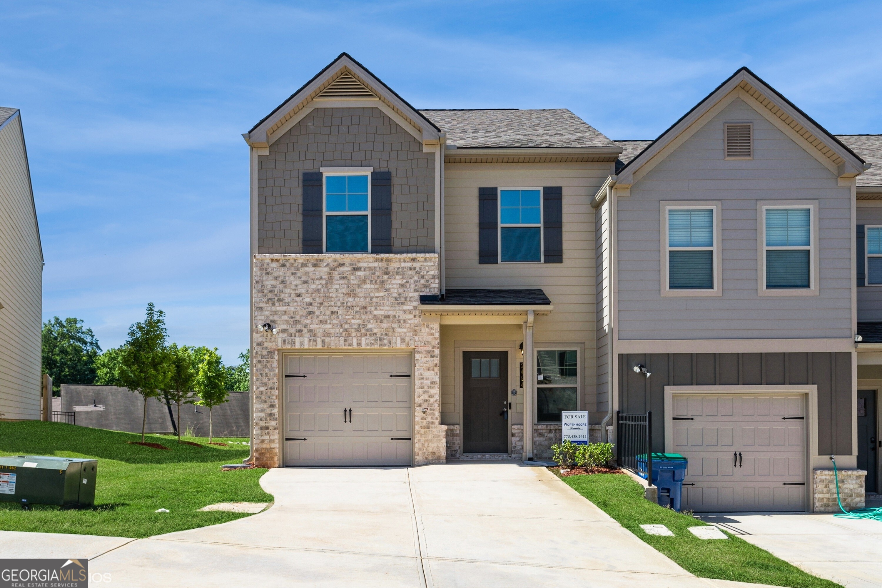 a front view of a house with a yard and garage