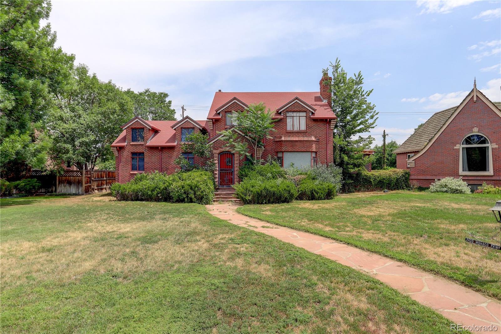 a front view of house with yard and trees