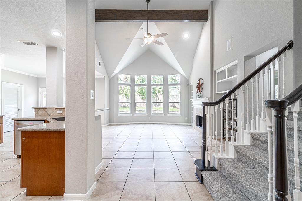 Your view from the foyer looking into the family room.  Your view through those beautiful windows is your paradise with pool and waterfall.