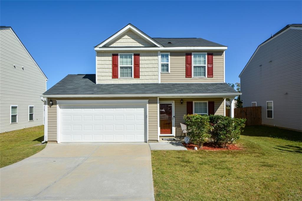 a front view of a house with a yard and garage