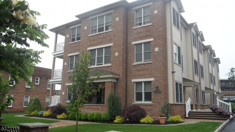 a view of a brick building next to a yard