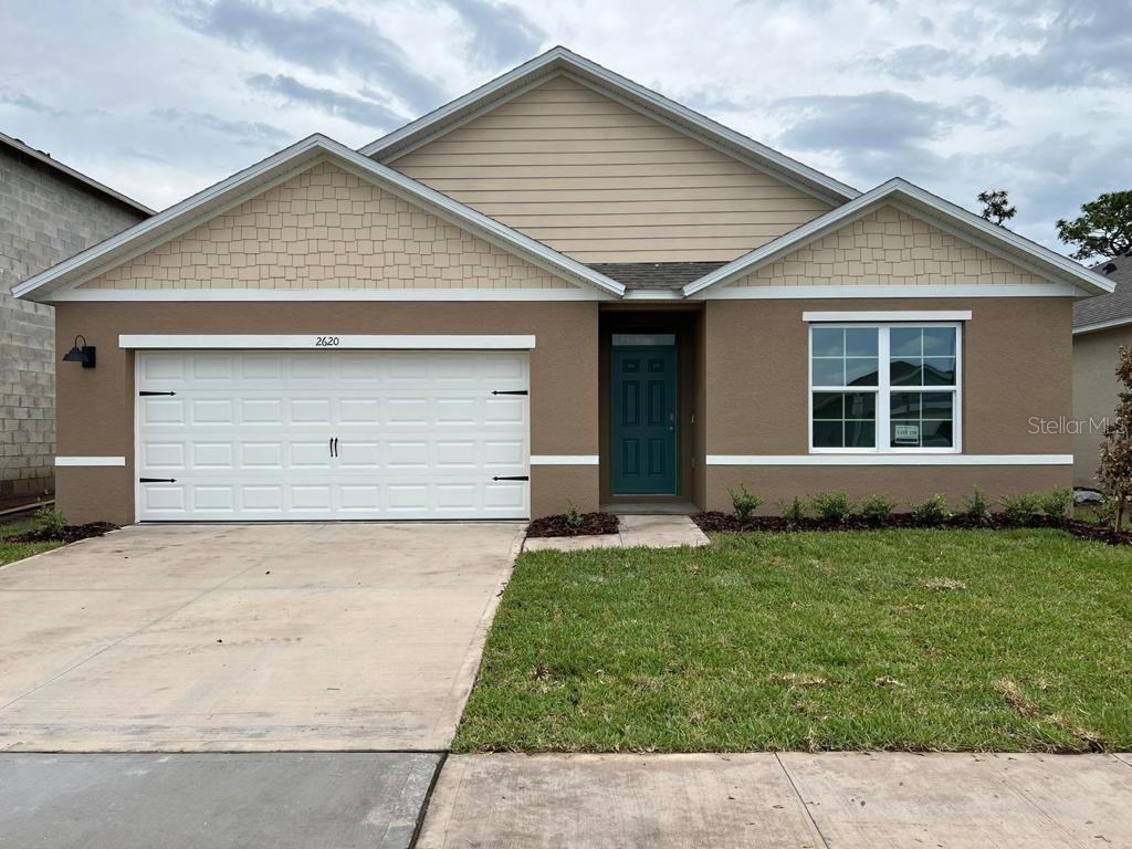 a front view of a house with a yard