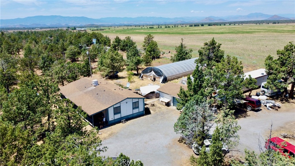 an aerial view of a house with a yard and lake view