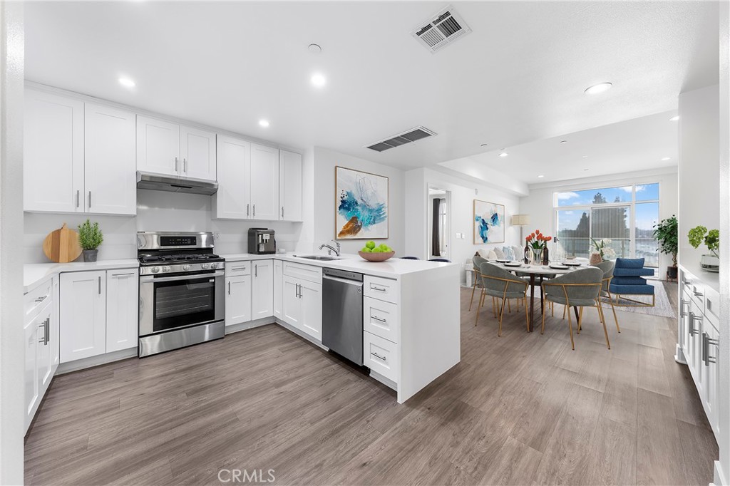 a kitchen that has a lot of cabinets in it and appliances