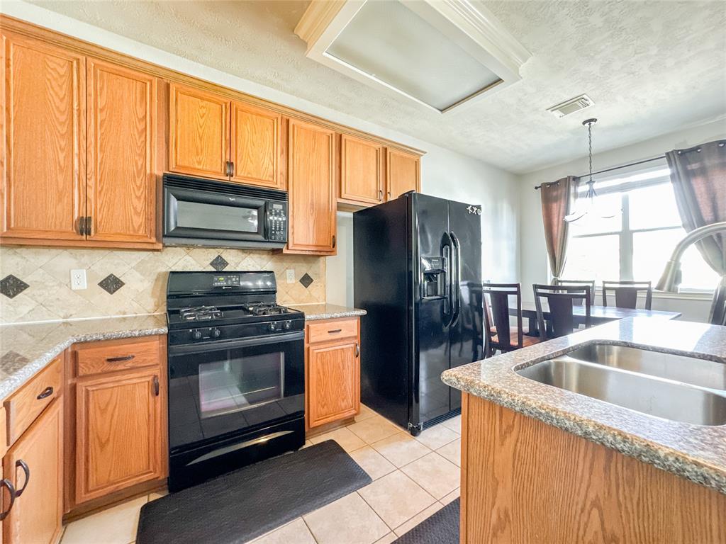 a kitchen with a refrigerator sink and microwave