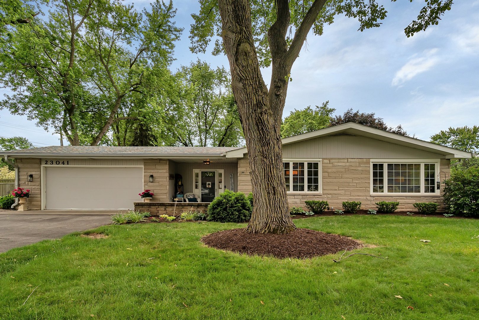 a front view of house with yard and green space