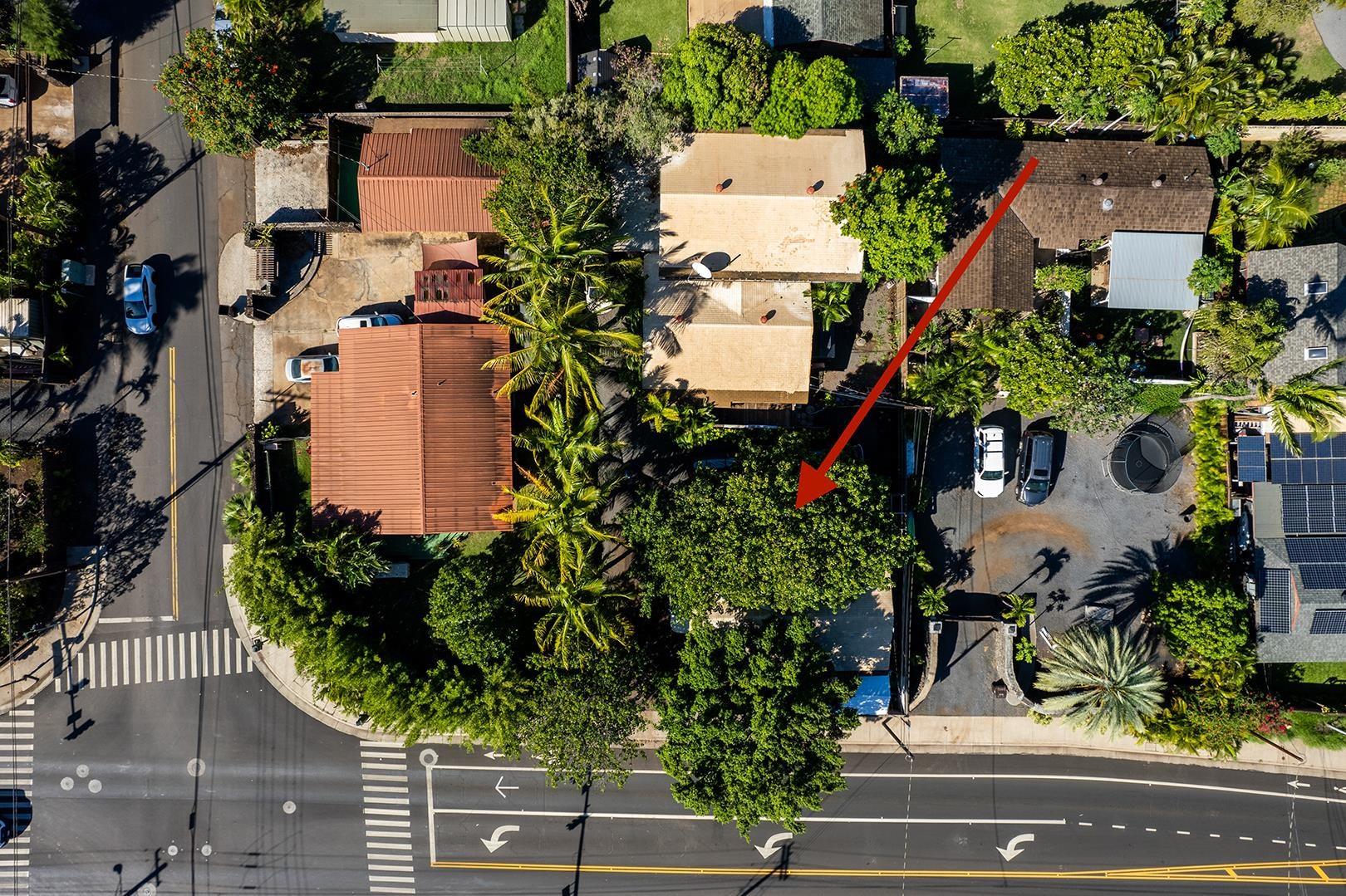 an aerial view of a house with a yard and seating space