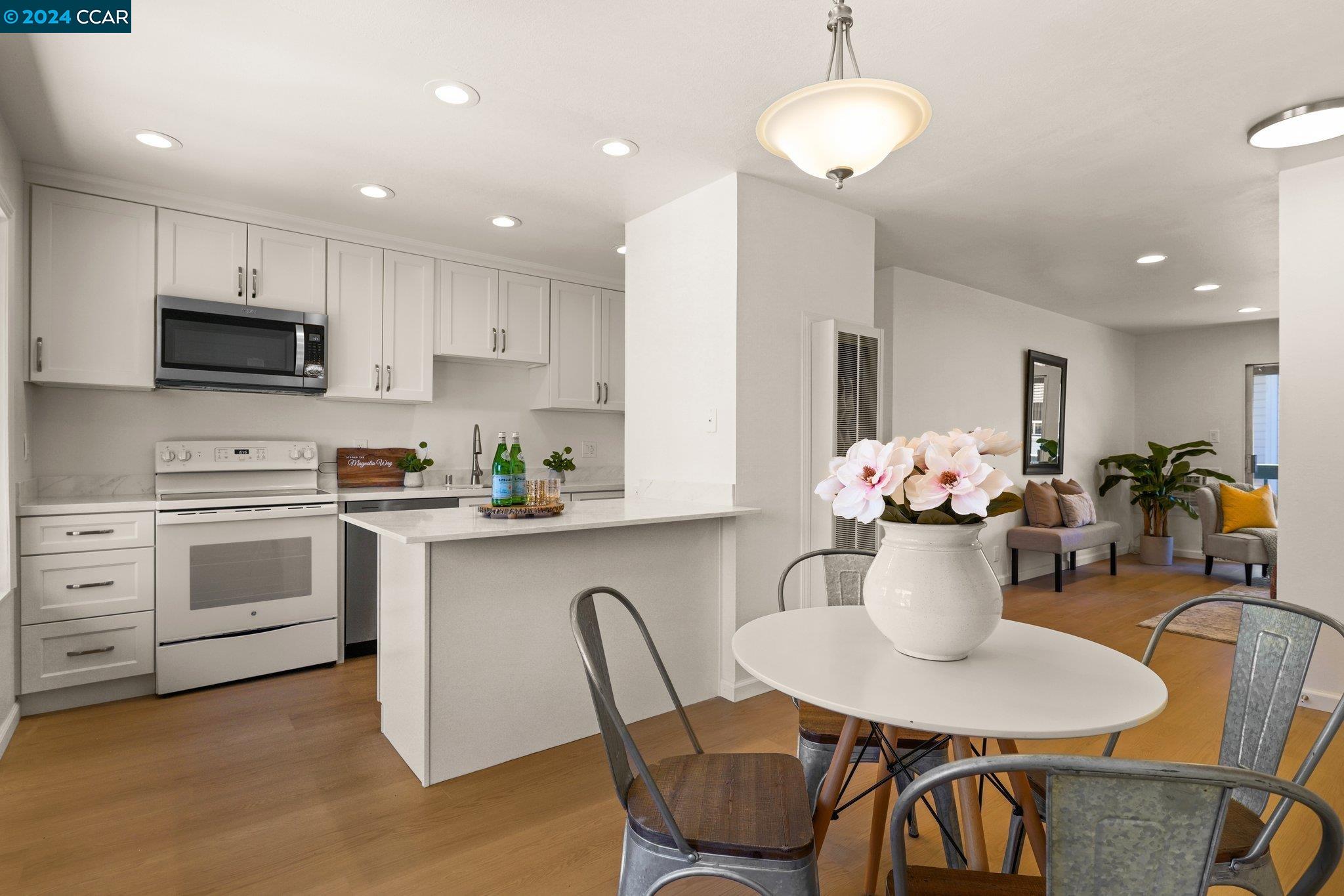 a kitchen with a dining table chairs and microwave