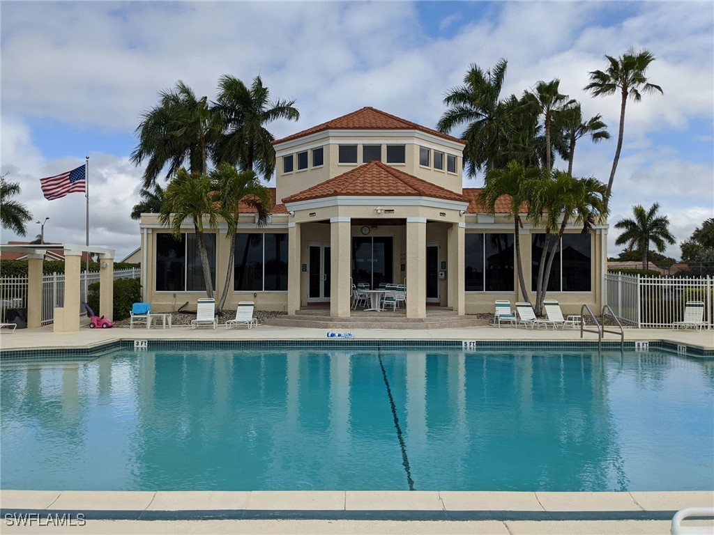 a view of house with swimming pool outdoor seating