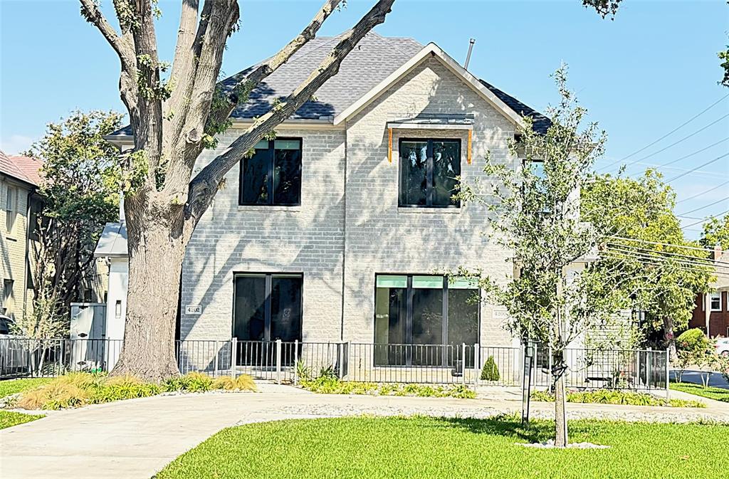 a house that has a tree in front of the house