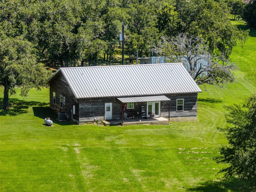 a view of a house with a yard and sitting area