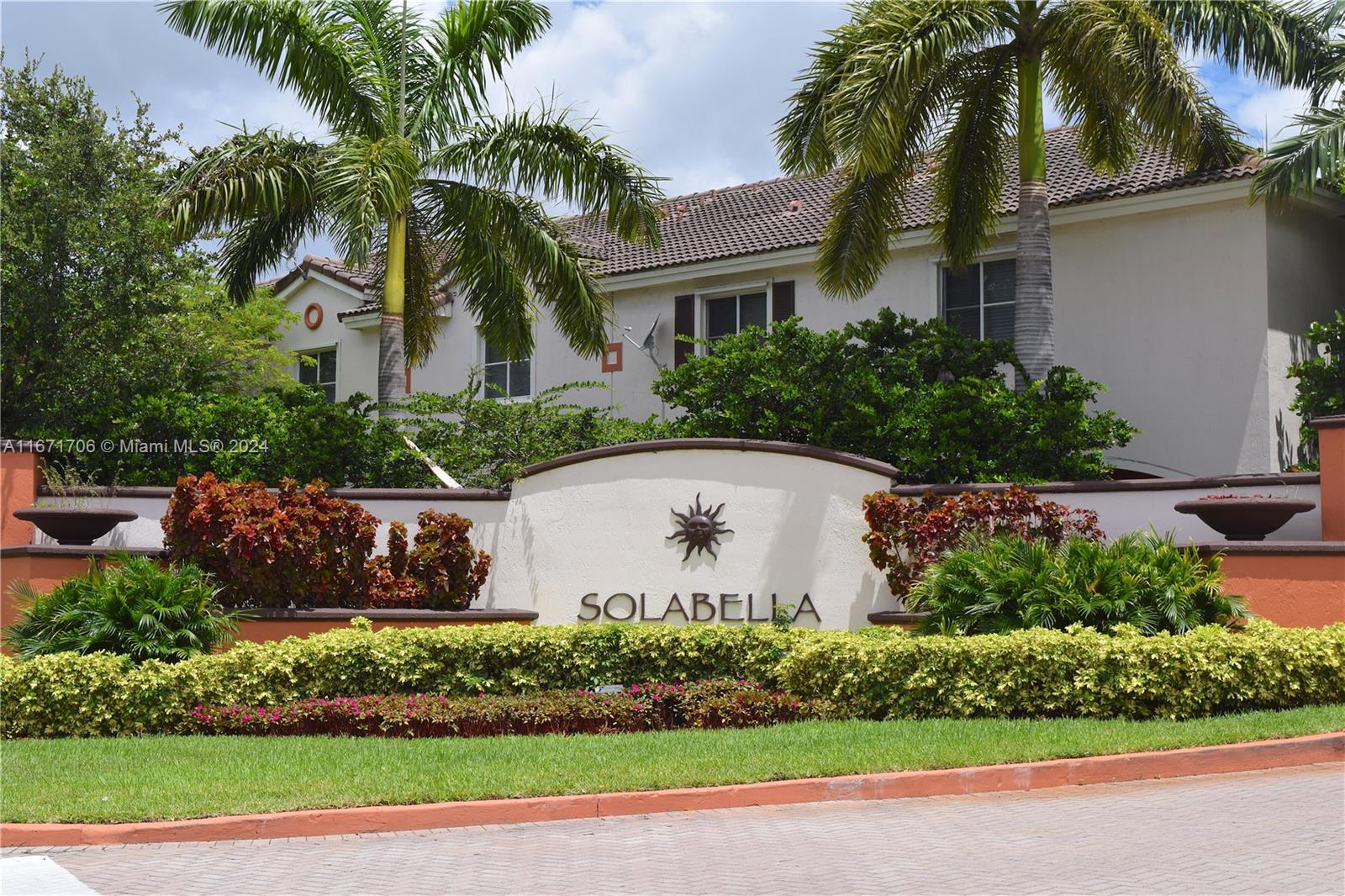 a view of house with palm trees