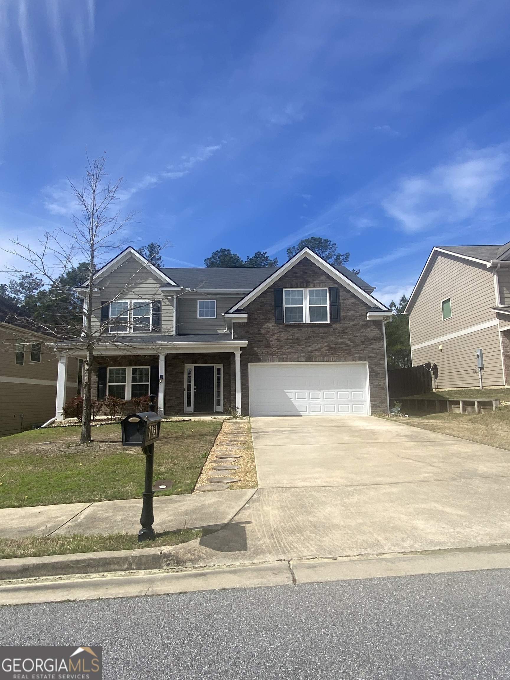 a front view of a house with a yard