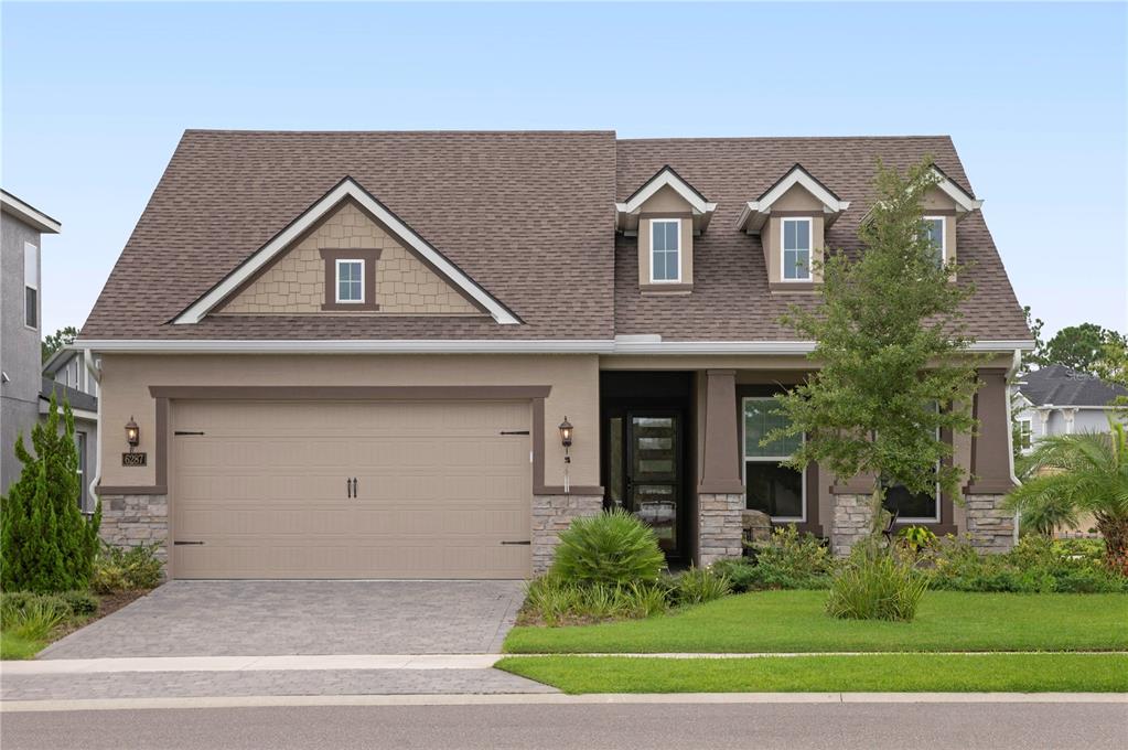 a front view of a house with a yard and garage