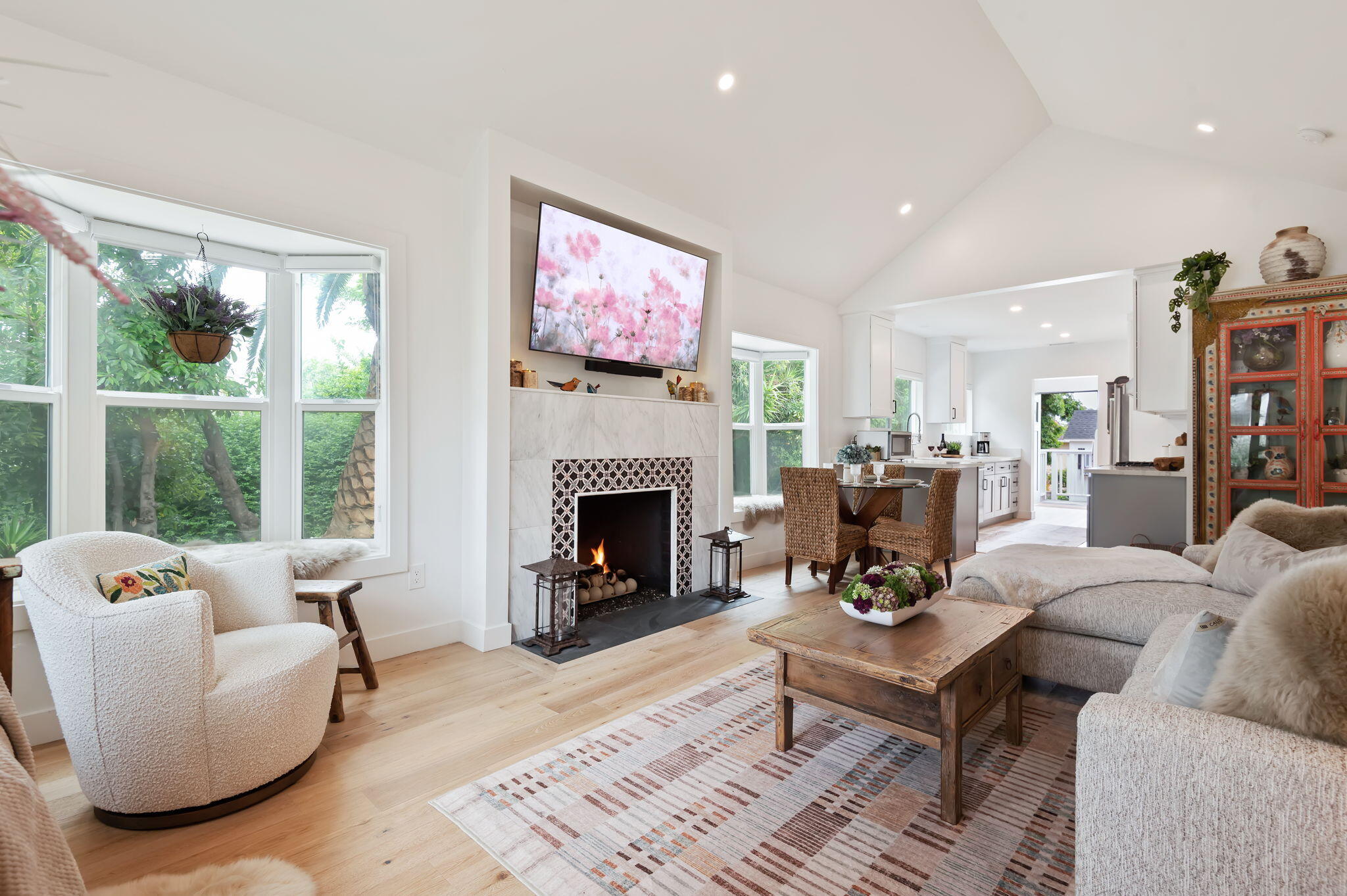 a living room with furniture fireplace and a large window