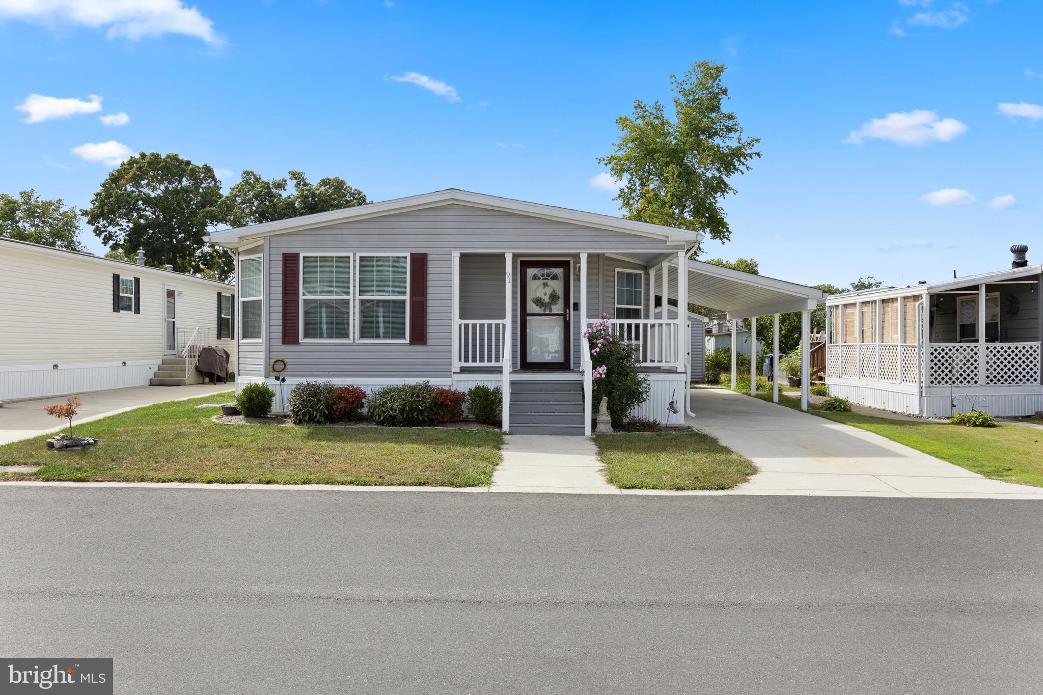 a front view of a house with a yard and porch