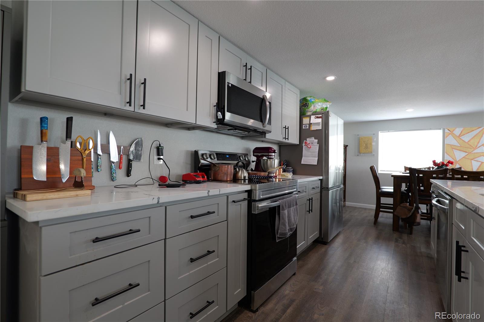 a kitchen with stainless steel appliances granite countertop counter space a sink and cabinets