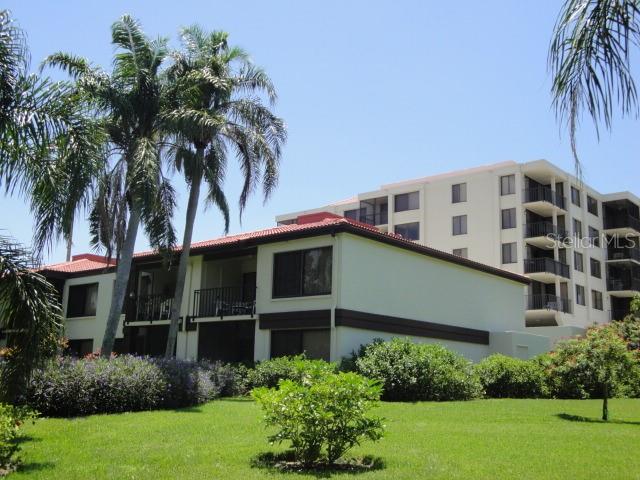 a front view of a house with a yard and a garage