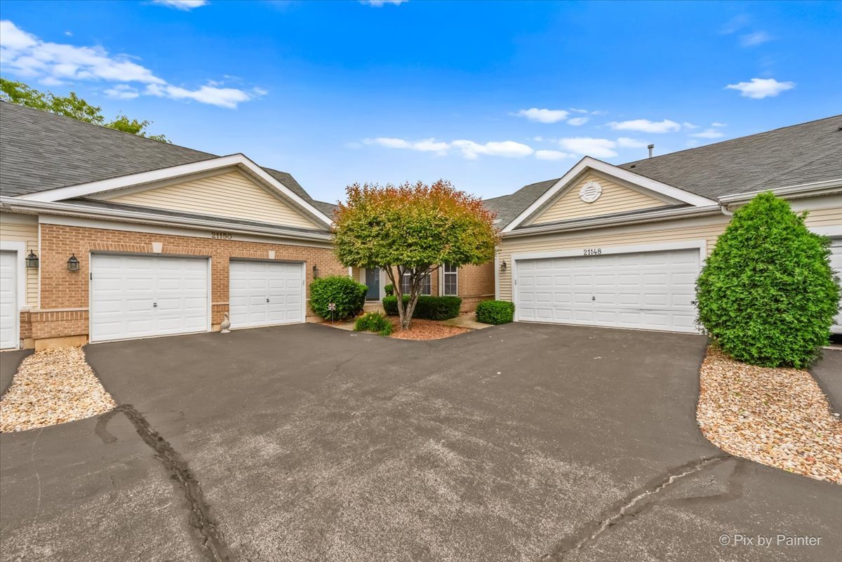 a front view of a house with a yard and garage