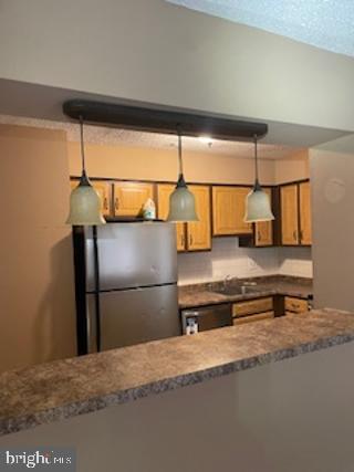 a kitchen with stainless steel appliances granite countertop a refrigerator sink and cabinets