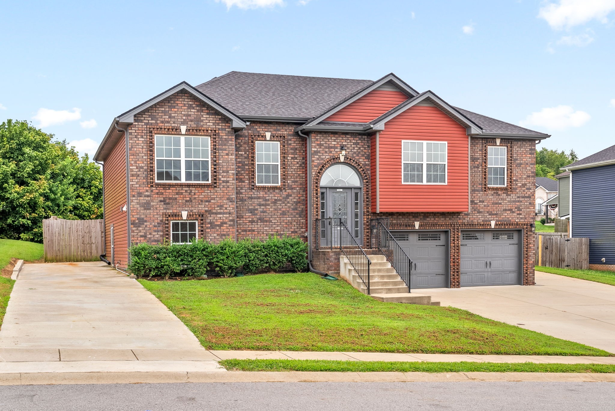 a front view of a house with a yard and garage