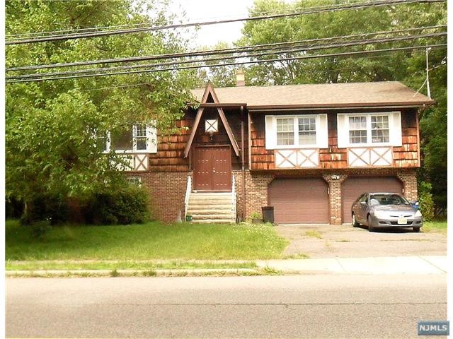 a view of a house with a patio and a yard