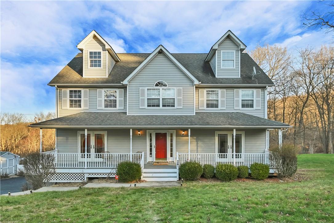 View of front of house with a porch and a front lawn