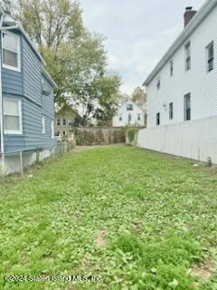 a view of house with backyard