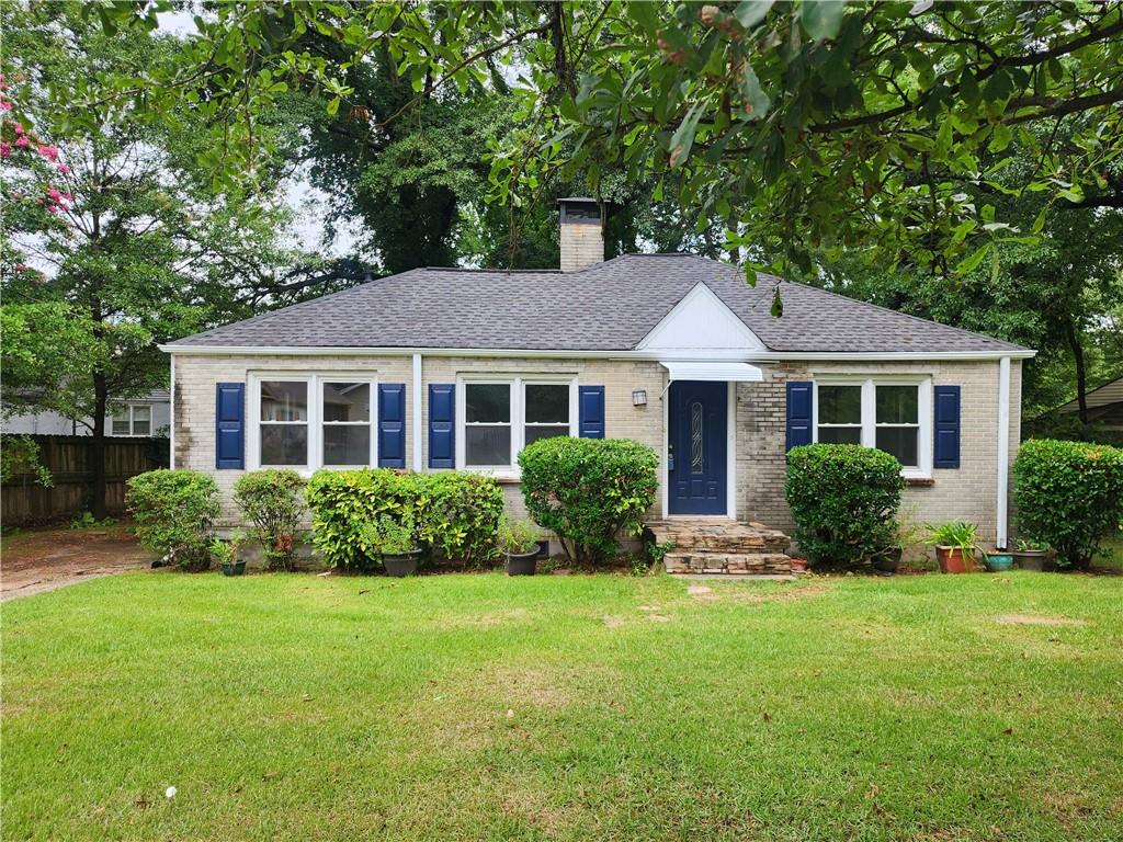 a front view of a house with a yard and outdoor seating