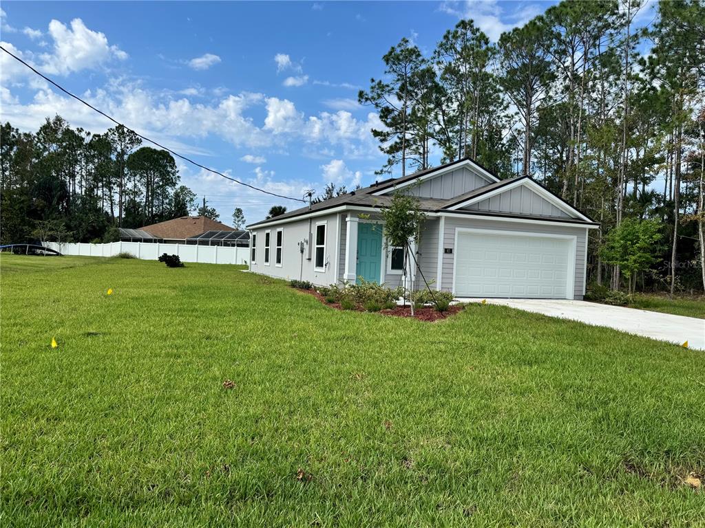 a front view of a house with a garden and yard