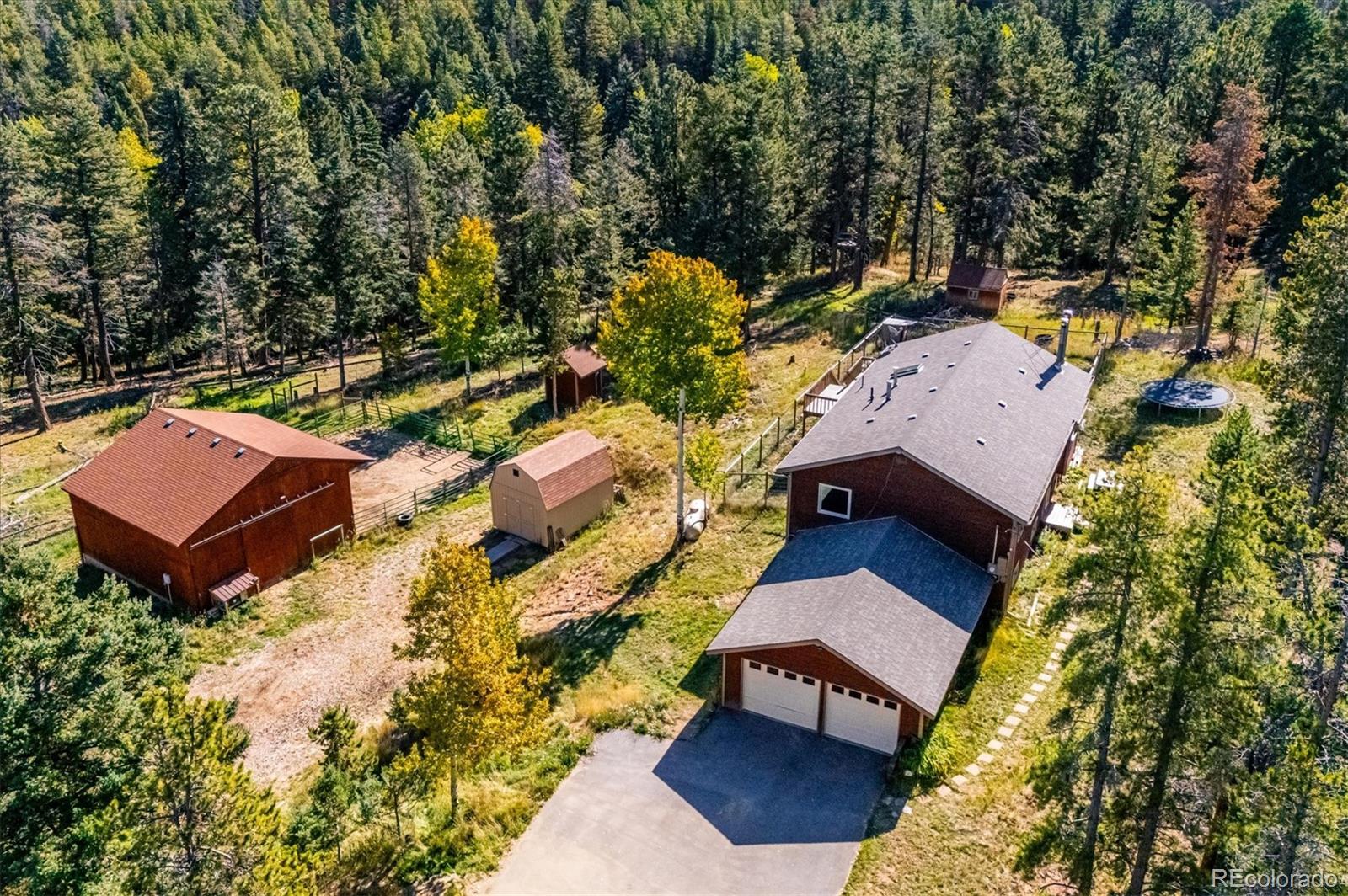 an aerial view of a house with a yard basket ball court and outdoor seating