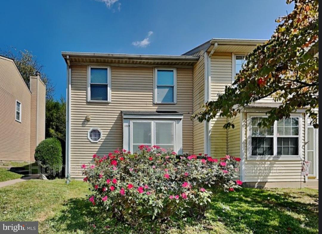 a flower garden is sitting in front of a house