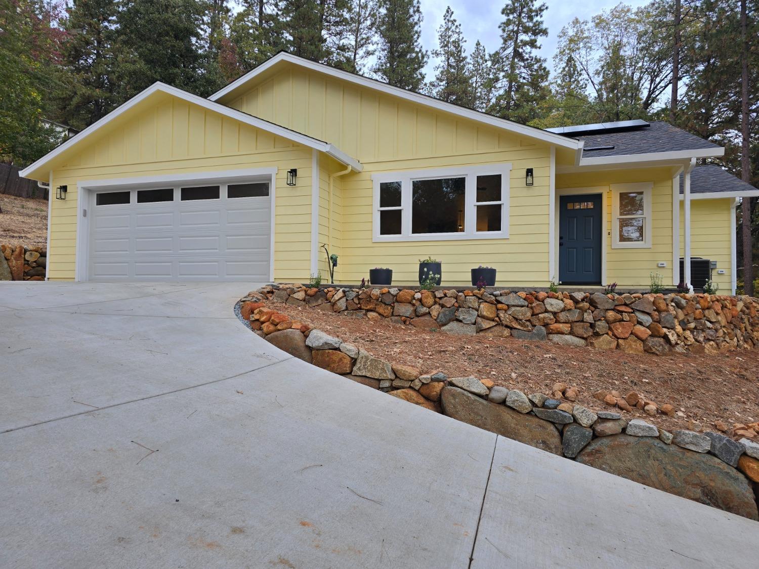 a front view of a house with trees