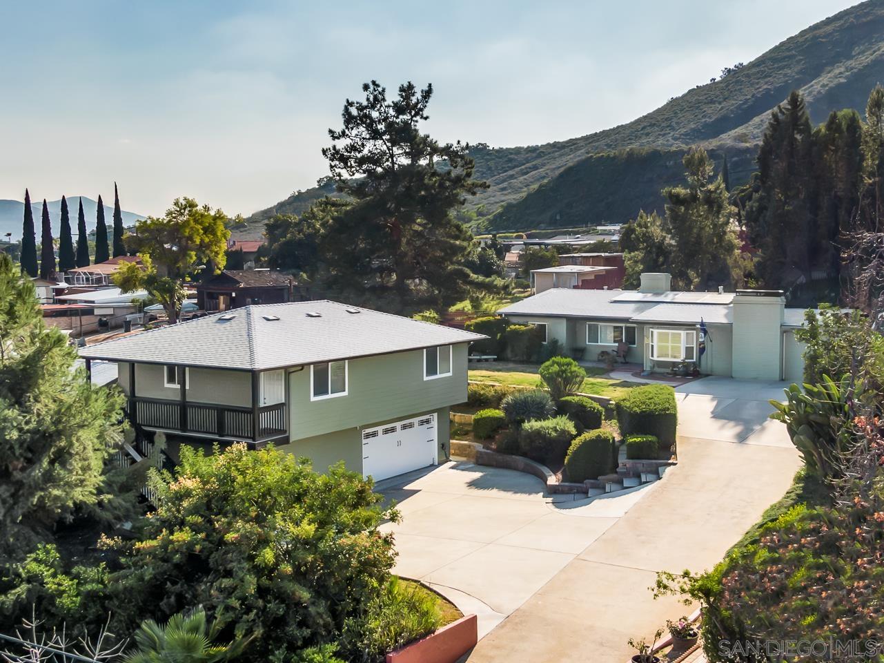 a aerial view of a house with a yard and sitting area