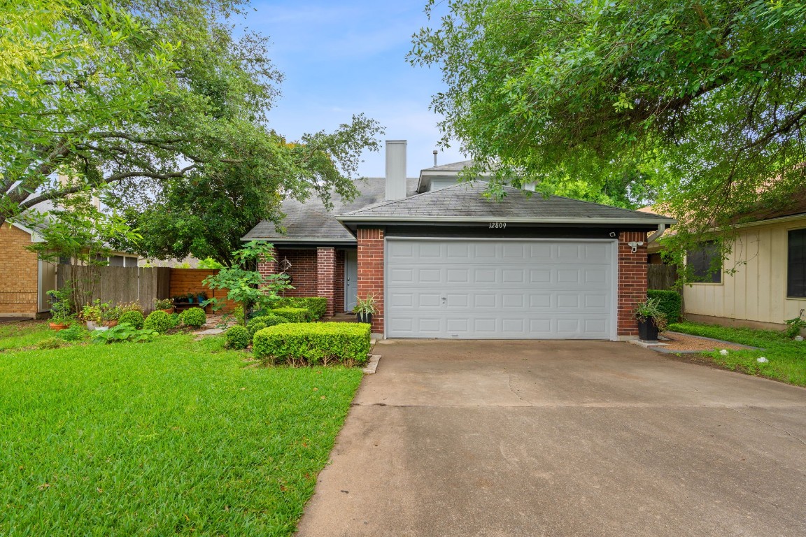 a front view of a house with a garden and plants