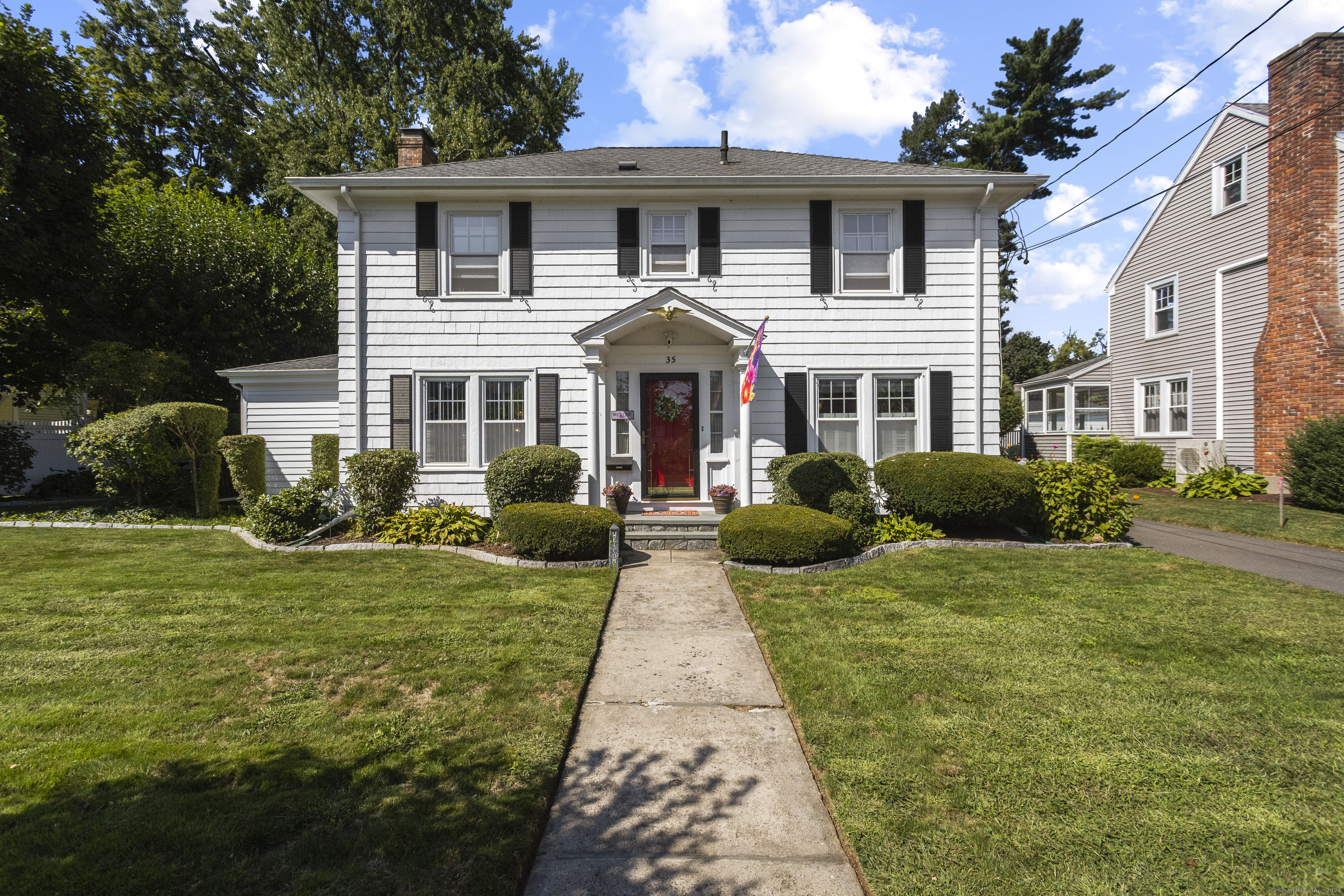 a front view of a house with a garden