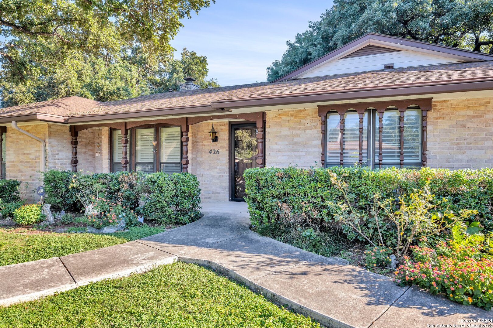 a front view of a house with garden