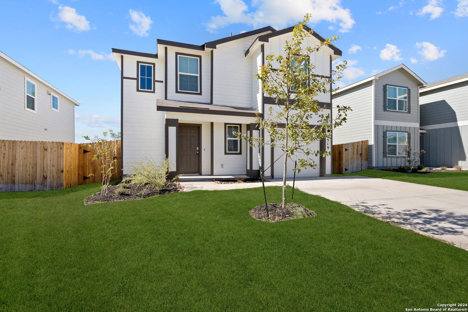 a front view of a house with a garden