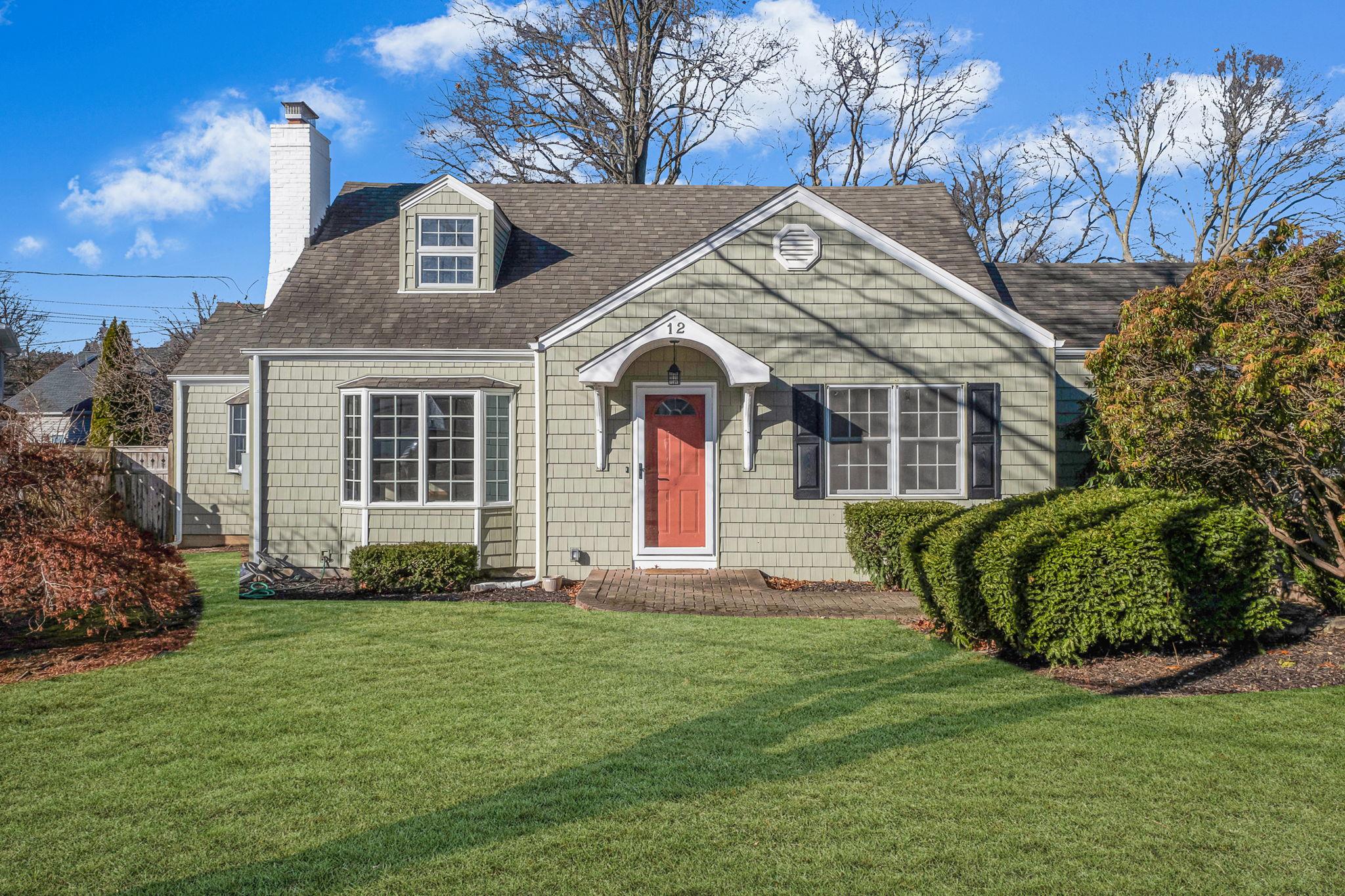 a front view of a house with a garden