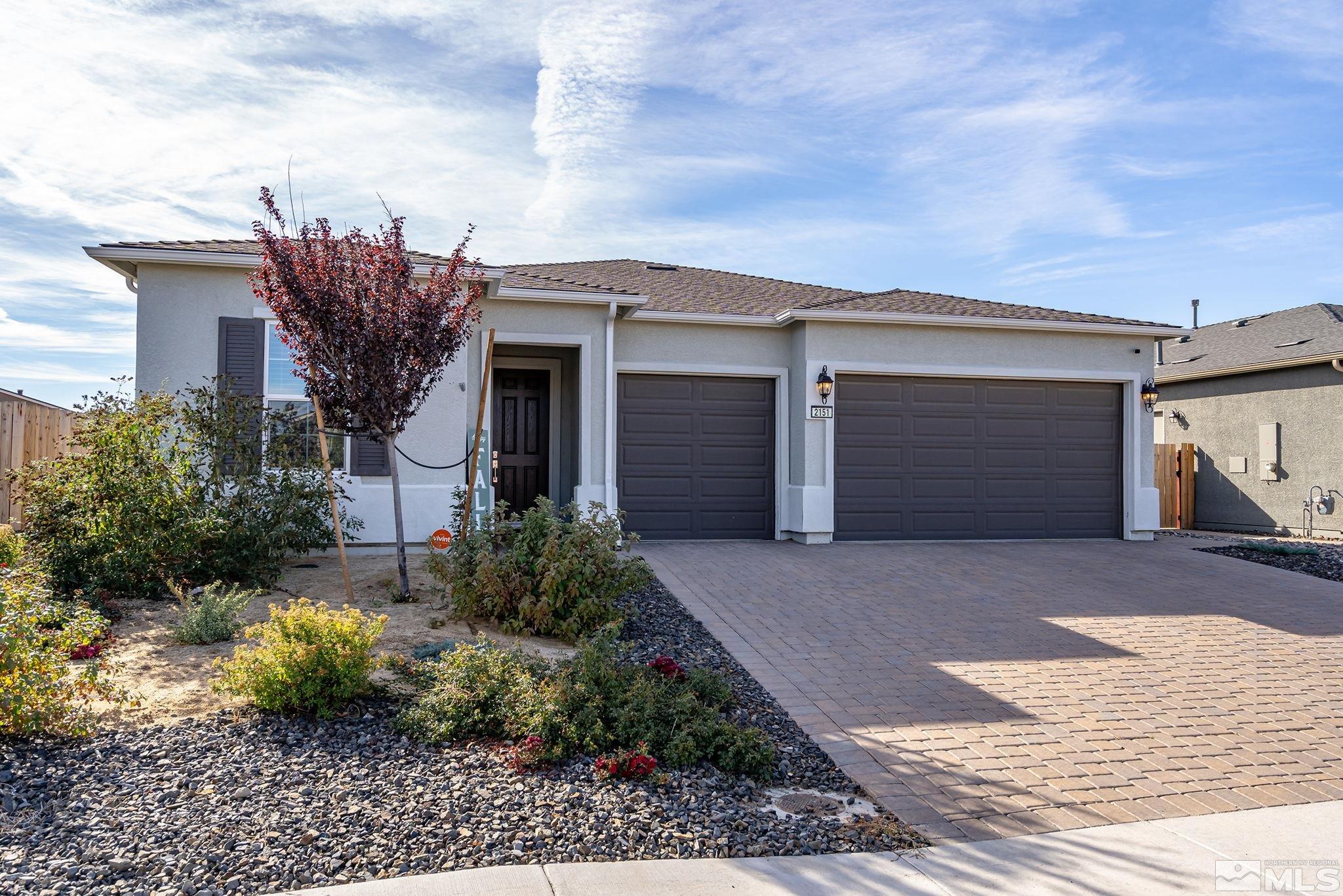 a front view of house with a yard and garage