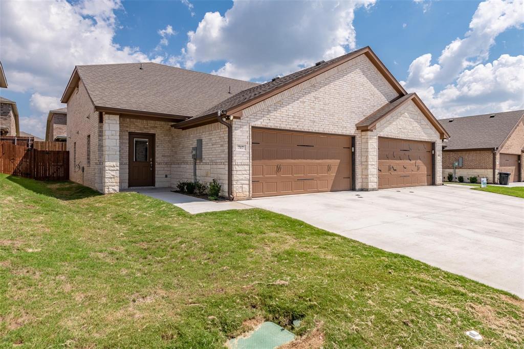 a view of a house with a yard and garage