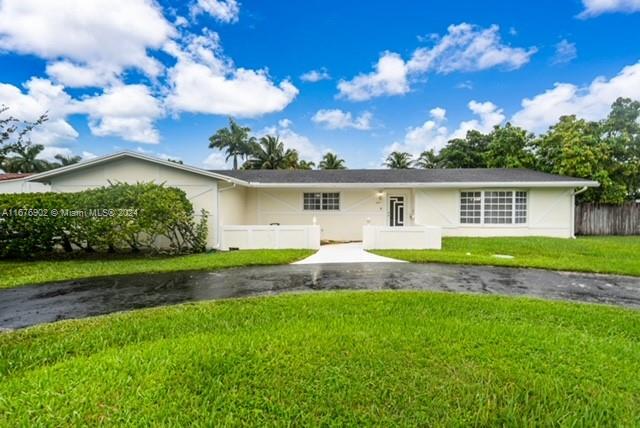 a view of a house with a backyard