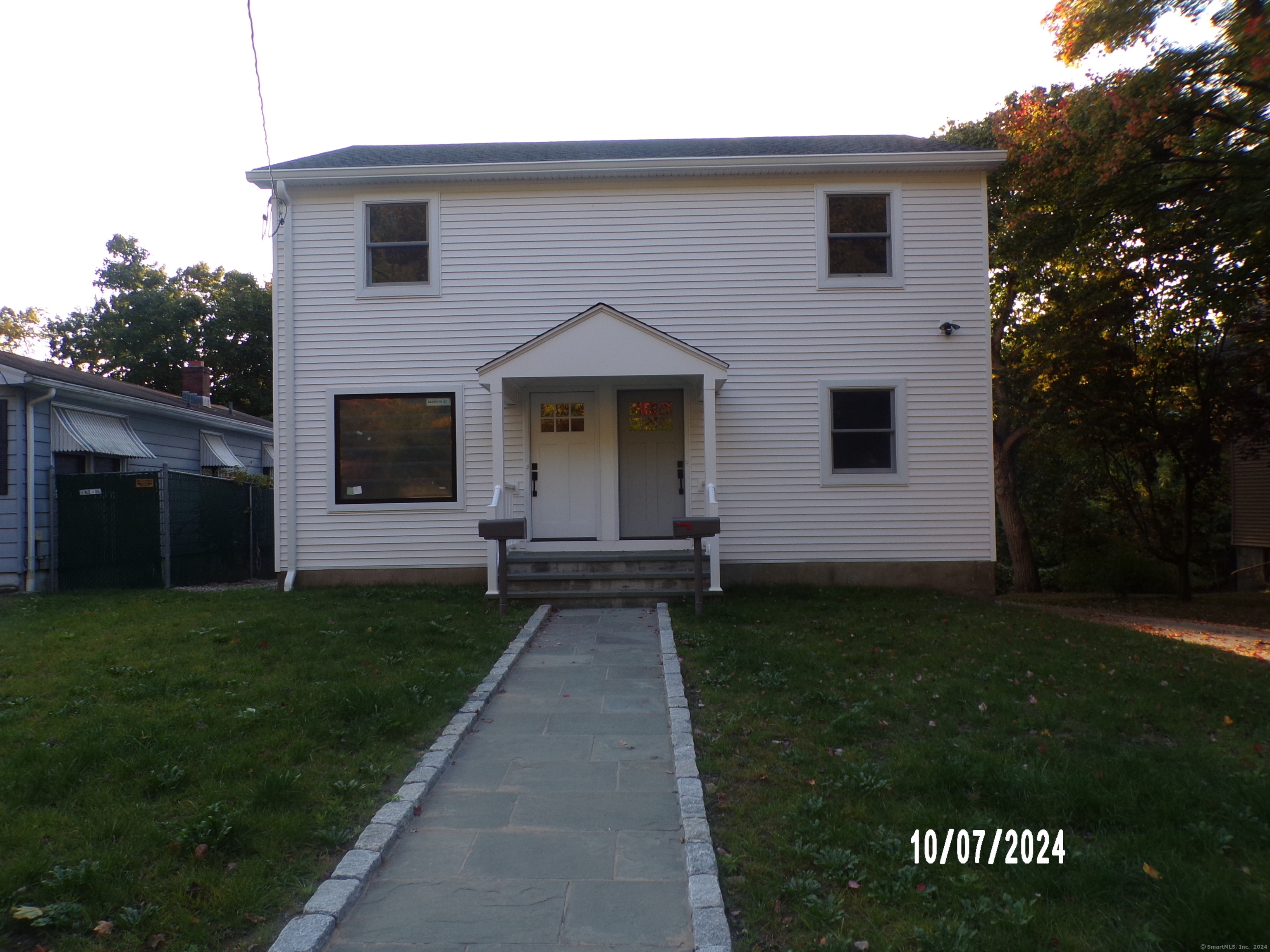 a front view of a house with a garden