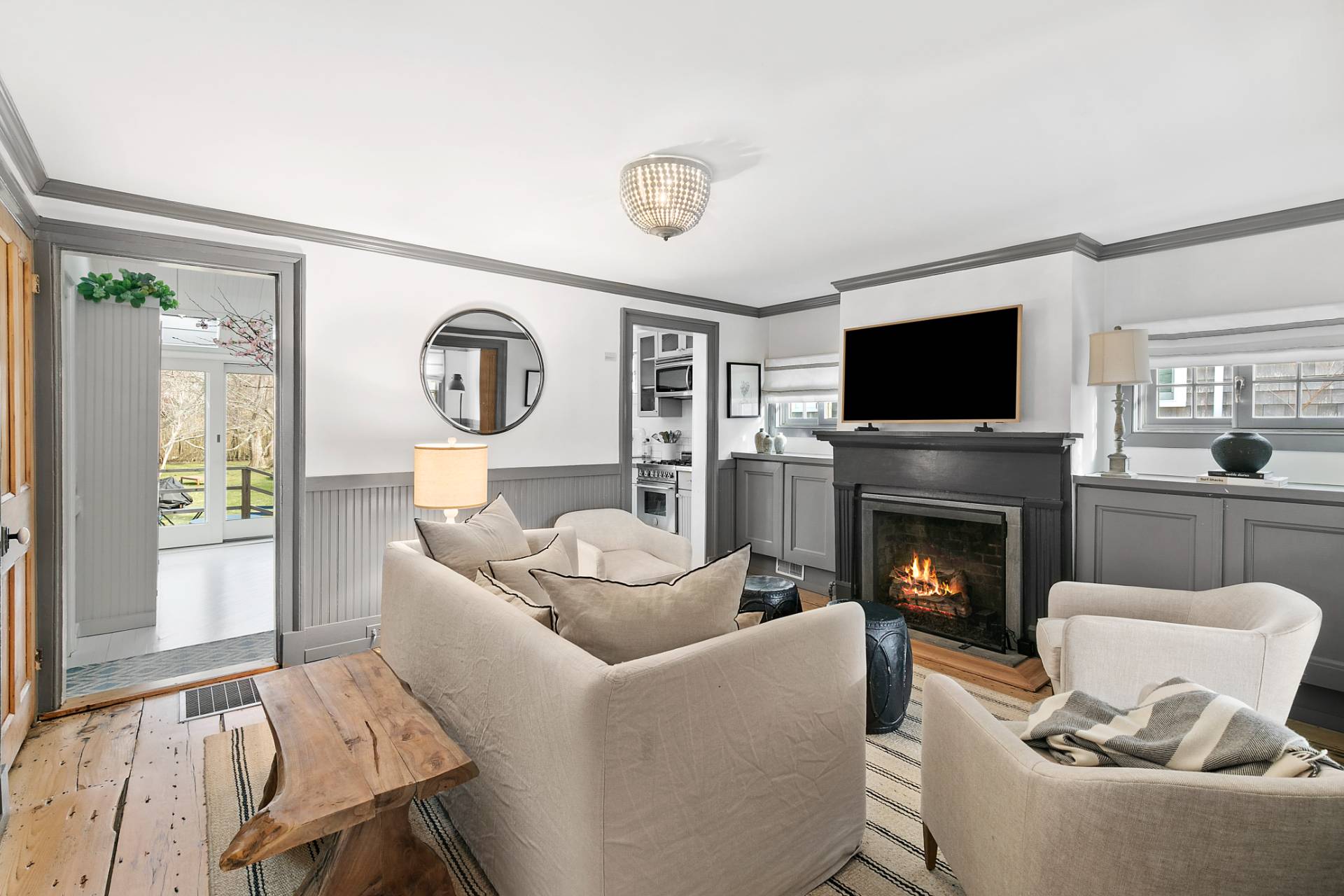 a living room with furniture a fireplace and a flat screen tv