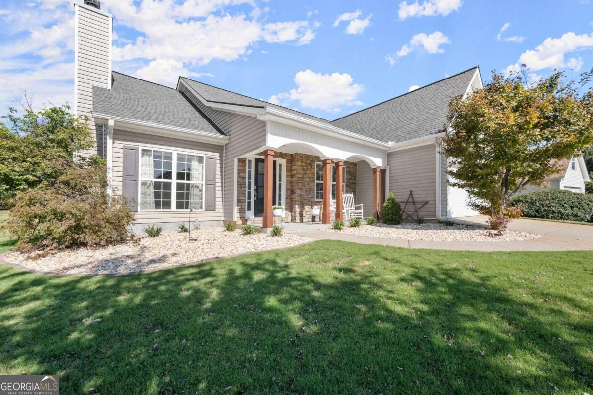 a front view of house with yard and outdoor seating