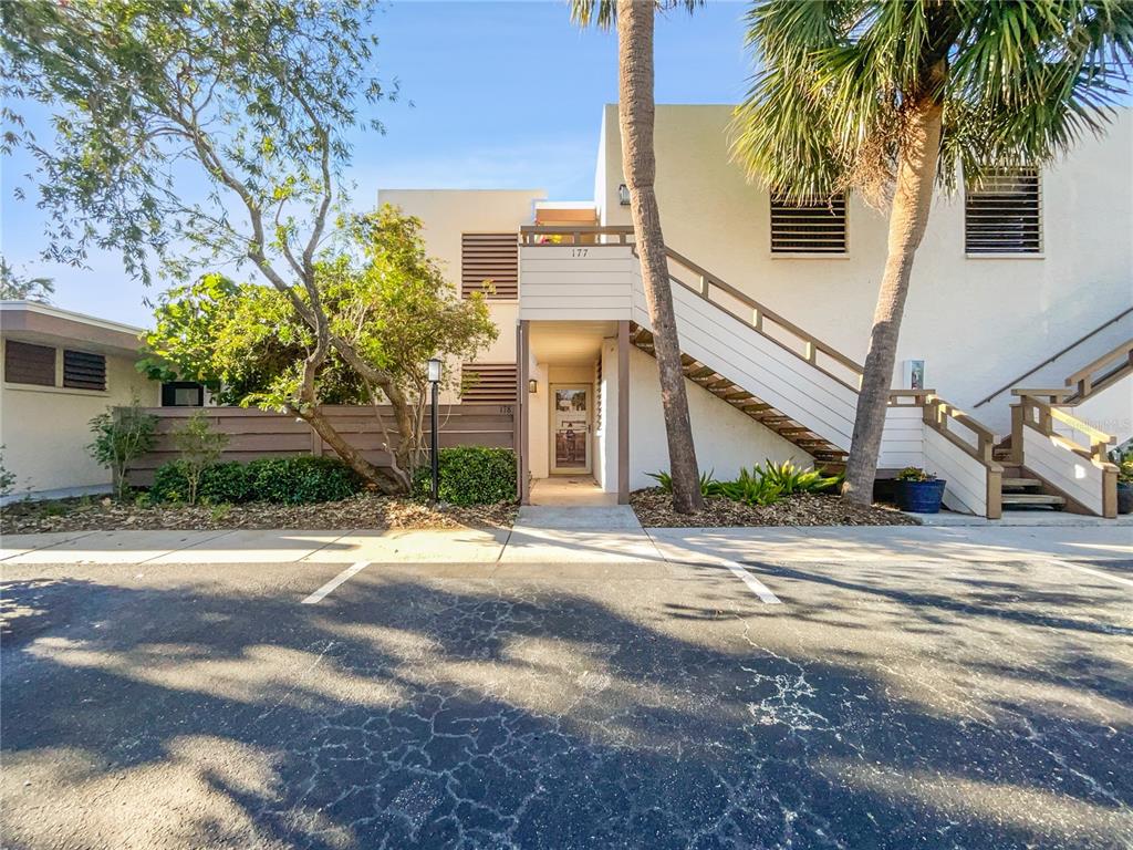 a front view of a house with palm trees