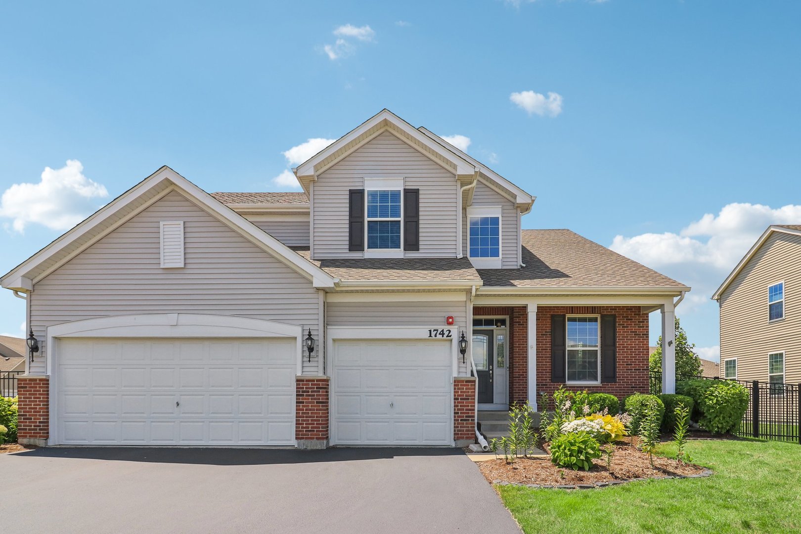 a front view of a house with a yard and garage