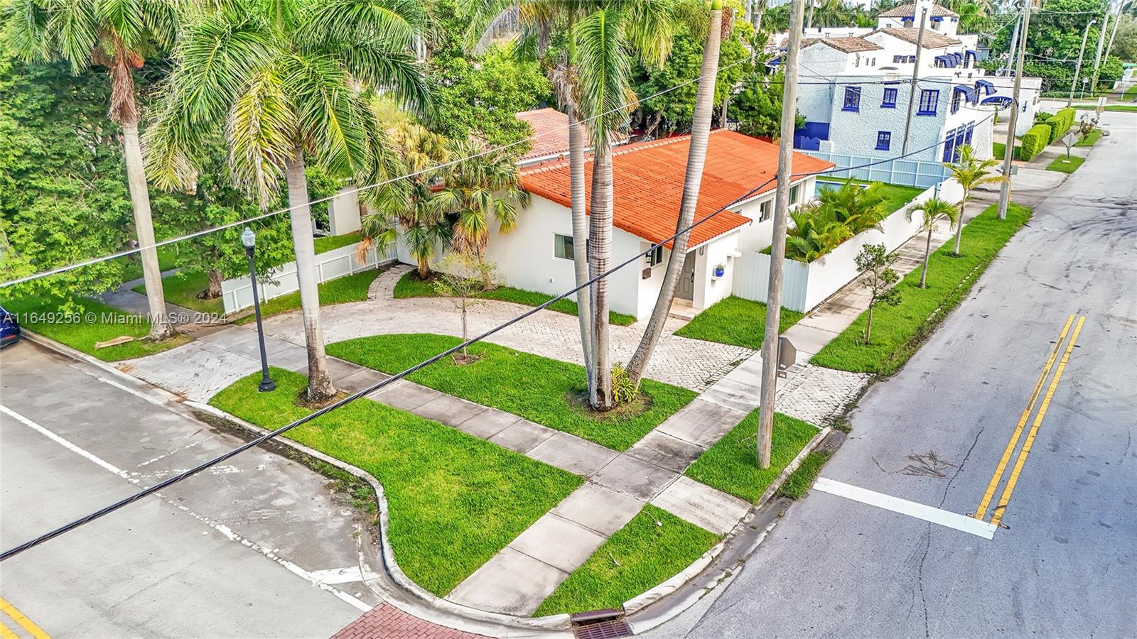 an aerial view of a house with a garden and swimming pool