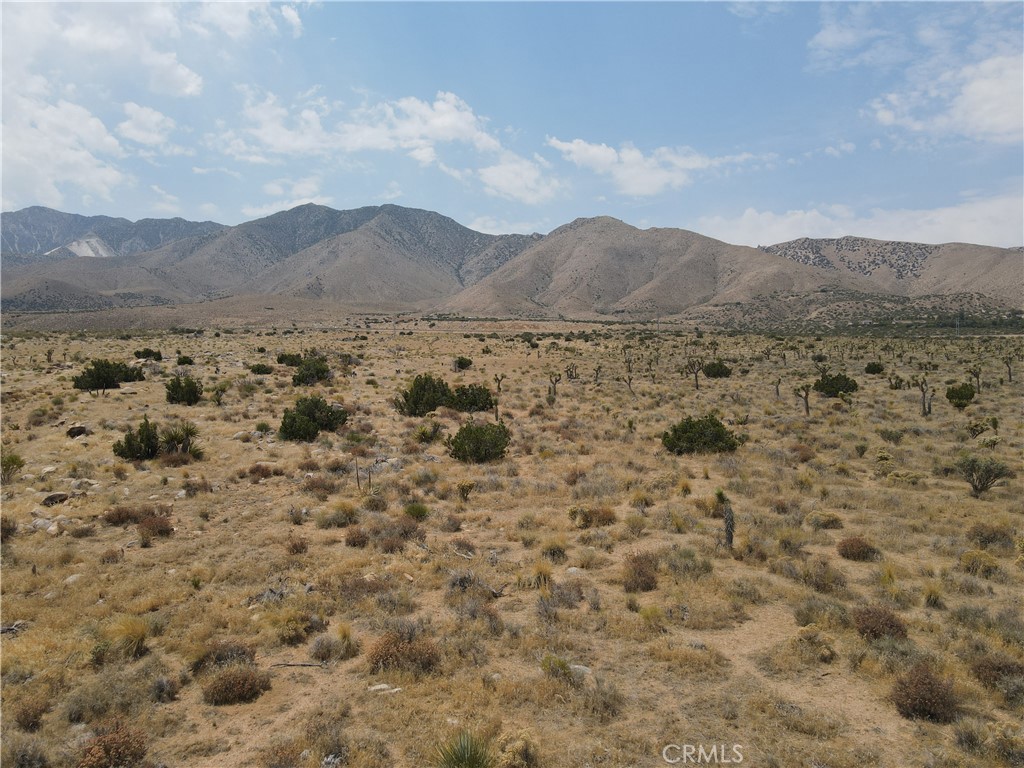 a view of a large mountain with mountains in the background